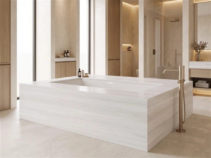 Bianco Dolomite marble bathtub deck with horizontally aligned veining and mitered corners in a custom bathroom