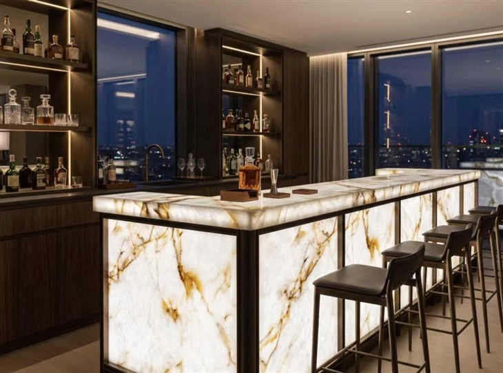 LED-backlit Cristallo Quartzite bar counter with a luminous white crystalline surface and natural gold-brown veining